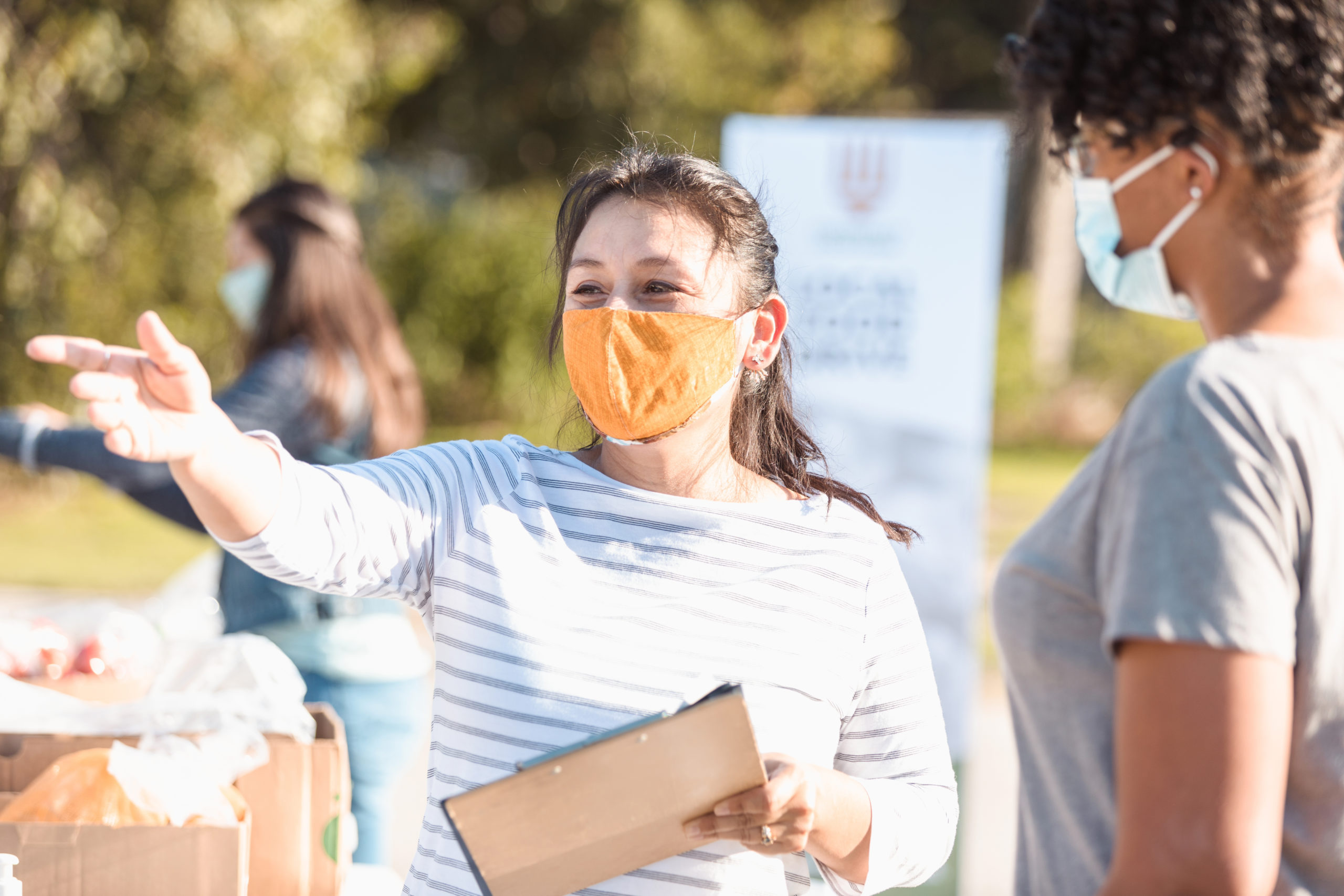 Volunteer coordinator gives instructions to female volunteer