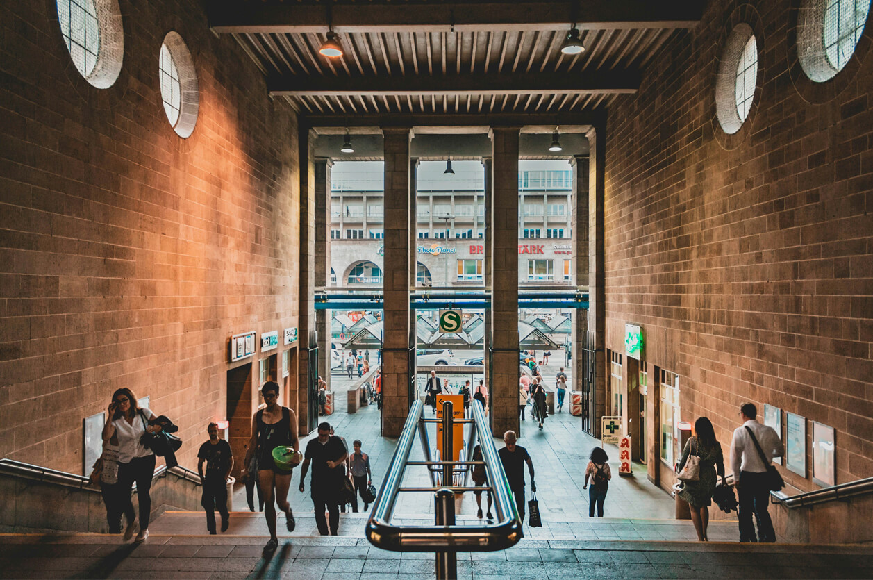 CommercialProperty-Scaled.tf Grand lobby of commercial building bustling with shoppers.