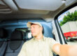 A distracted delivery driver looks out the passenger-side window.