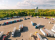 Aerial view of a trucking rest stop with parking area full of semi trucks.
